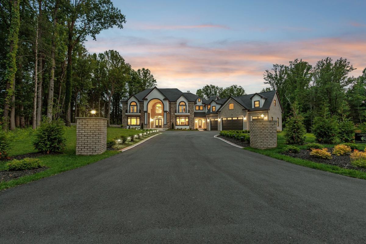 11721 Plantation Dr, a stone estate at the end of a long gated drive