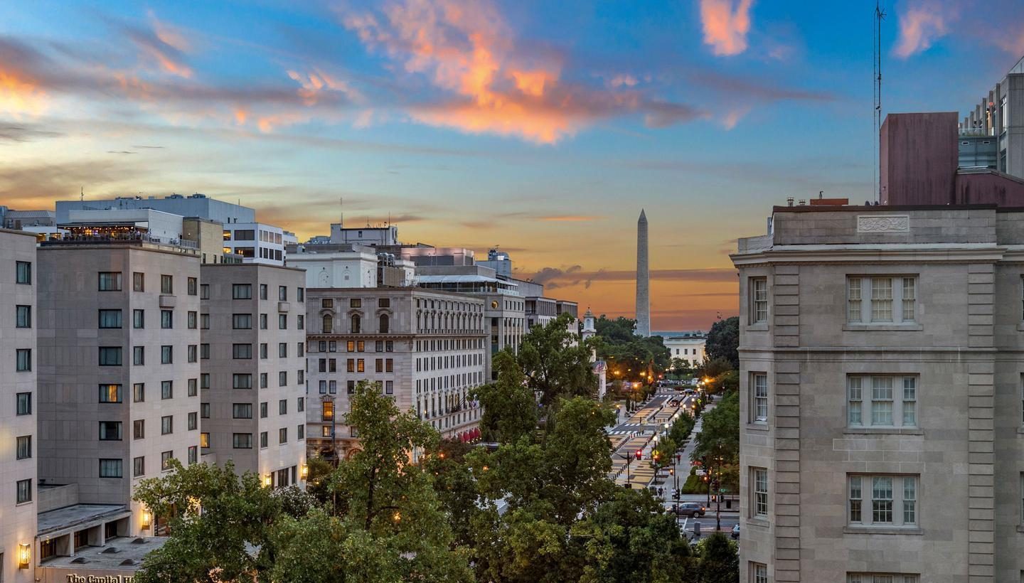 View down 16th Street NW to the Washington Monument at dusk, from 1108 16th St NW